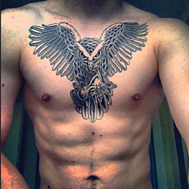 Black And Grey Owl With Hourglass Tattoo On Man Chest