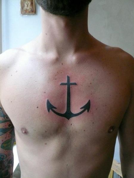 Black Cross Anchor Tattoo On Man Chest