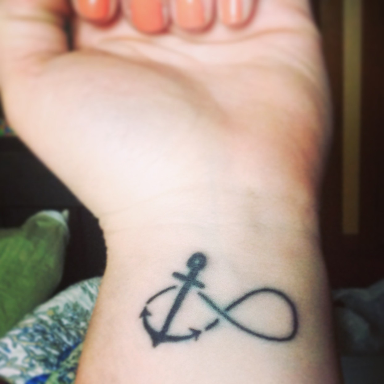 Black Infinity With Anchor Tattoo On Girl Left Wrist