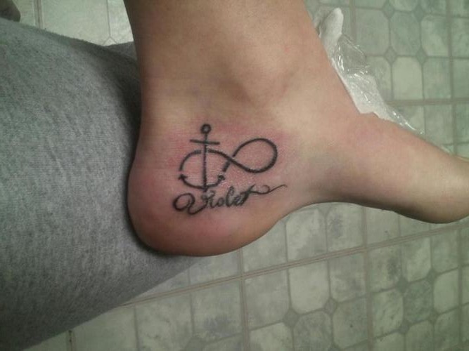 Black Infinity With Anchor Tattoo On Heel