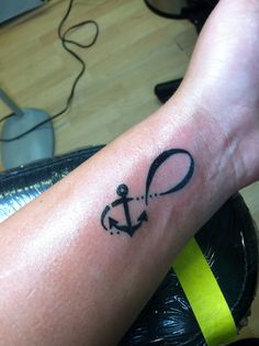 Black Infinity With Anchor Tattoo On Left Wrist