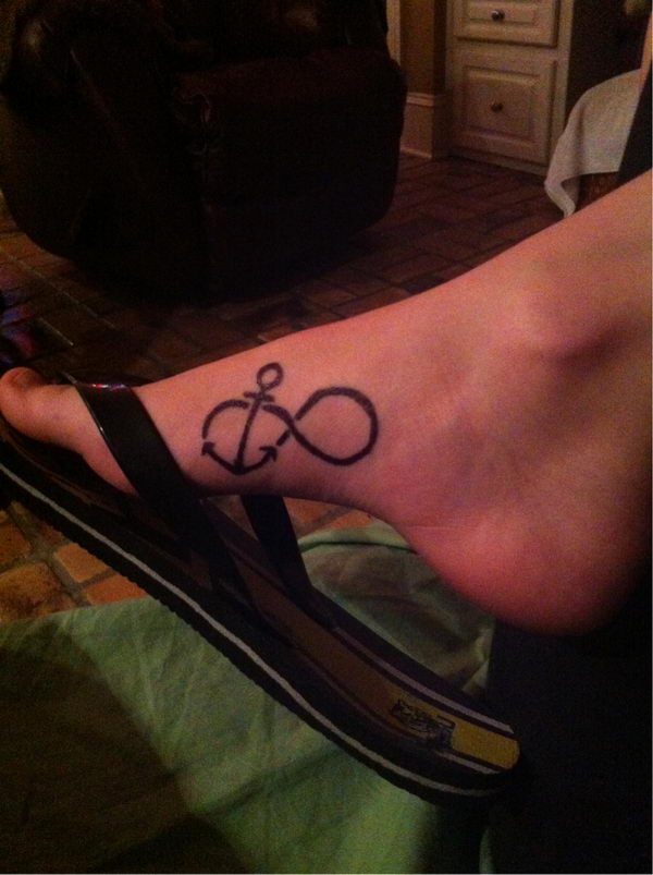 Black Infinity With Anchor Tattoo On Right Foot