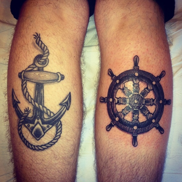 Black Ink Anchor And Ship Wheel Tattoo On Both Leg Calf