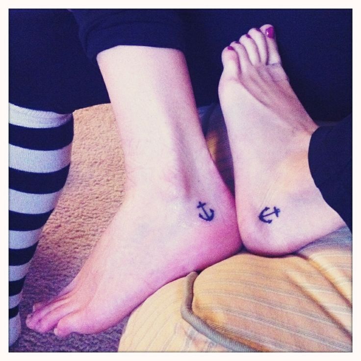 Black Ink Anchor Tattoo On Couple Heel