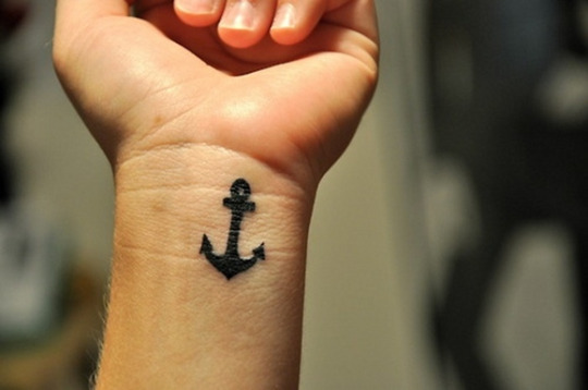 Black Ink Anchor Tattoo On Man Left Wrist