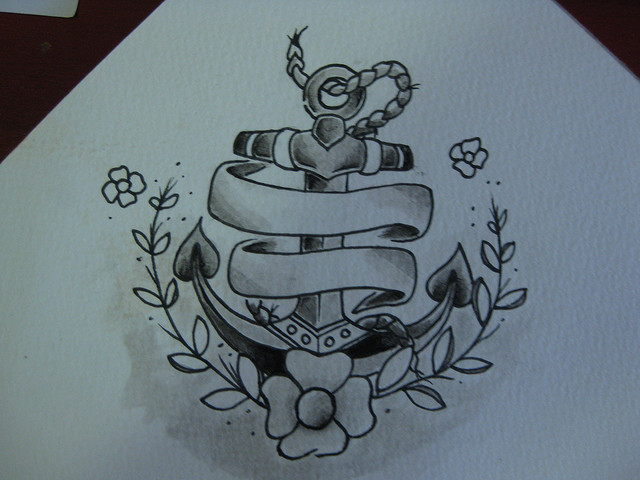 Black Ink Anchor With Banner And Flowers Tattoo Design