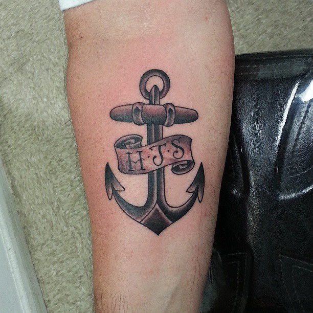 Black Ink Anchor With Banner Tattoo On Forearm