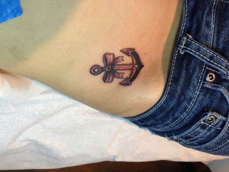 Black Ink Anchor With Bow Tattoo On Girl Right Hip