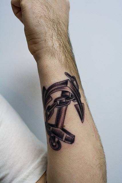 Black Ink Anchor With Chain Tattoo On Forearm