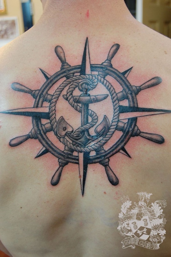 Black Ink Anchor With Compass And Ship Wheel Tattoo On Upper Back