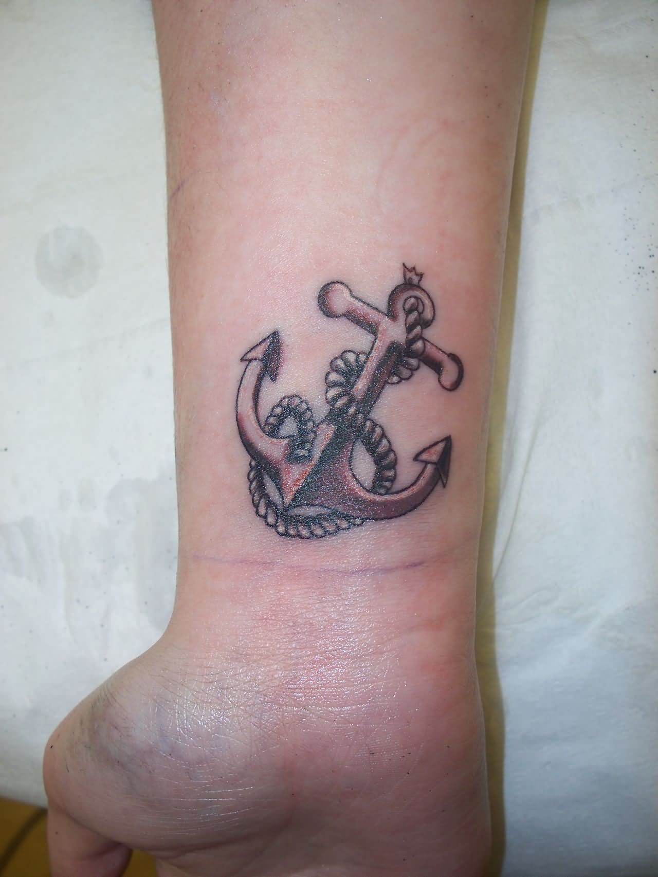 Black Ink Anchor With Rope Tattoo On Right Wrist