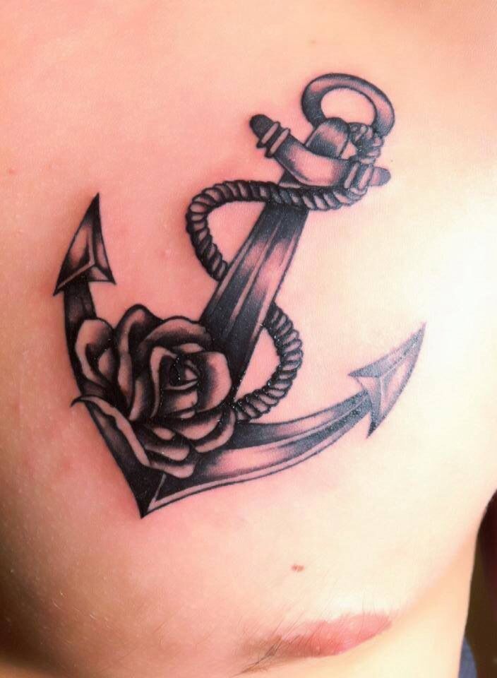 Black Ink Anchor With Rose Tattoo On Man Chest