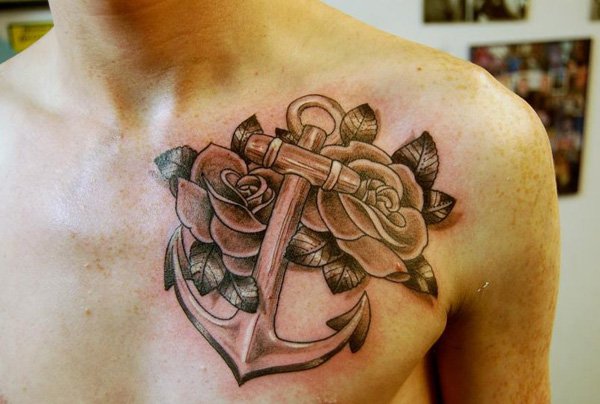 Black Ink Anchor With Roses Tattoo On Man Left Chest