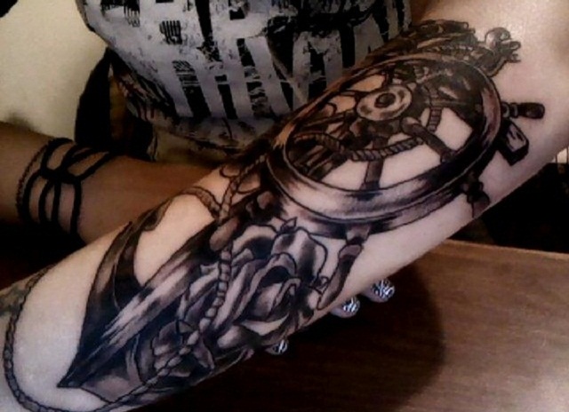 Black Ink Anchor With Ship Wheel And Rose Tattoo On Girl Left Arm