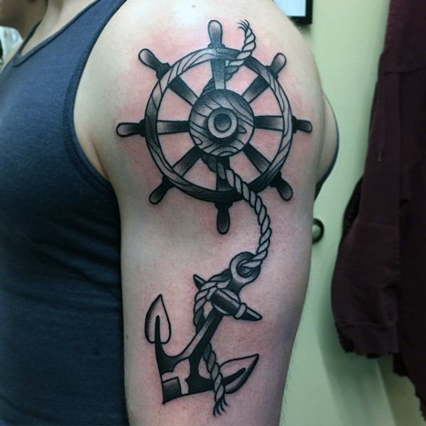 Black Ink Anchor With Ship Wheel Tattoo On Man Left Half Sleeve
