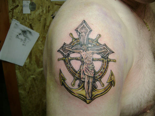 Black Ink Jesus On Anchor Cross With Ship Wheel Tattoo On Man Right Shoulder