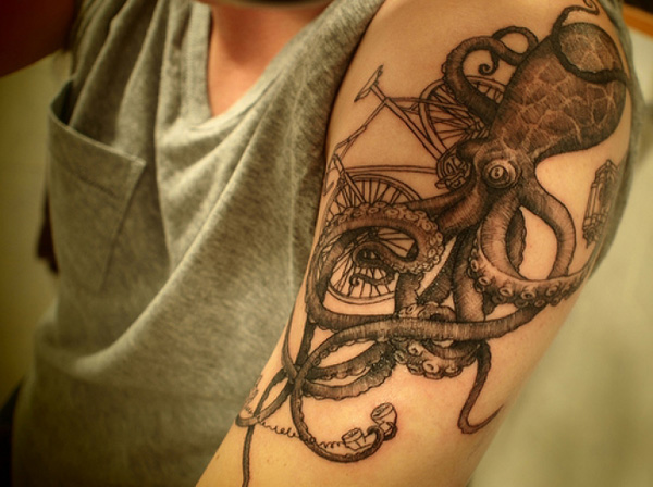 Black Ink Octopus With Cycle Tattoo On Man Left Shoulder