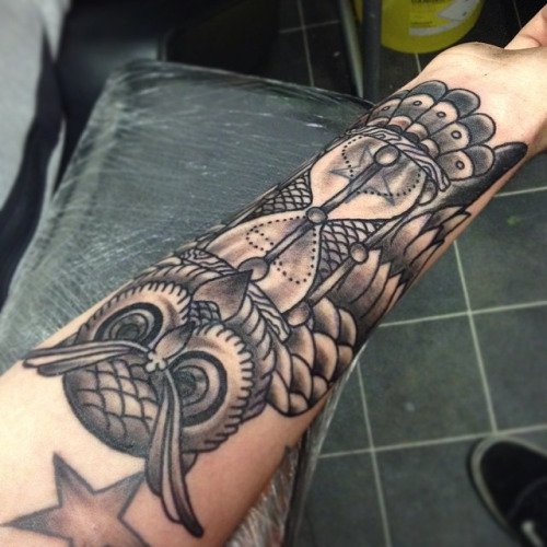 Black Ink Owl Hourglass Tattoo Design On Left Forearm
