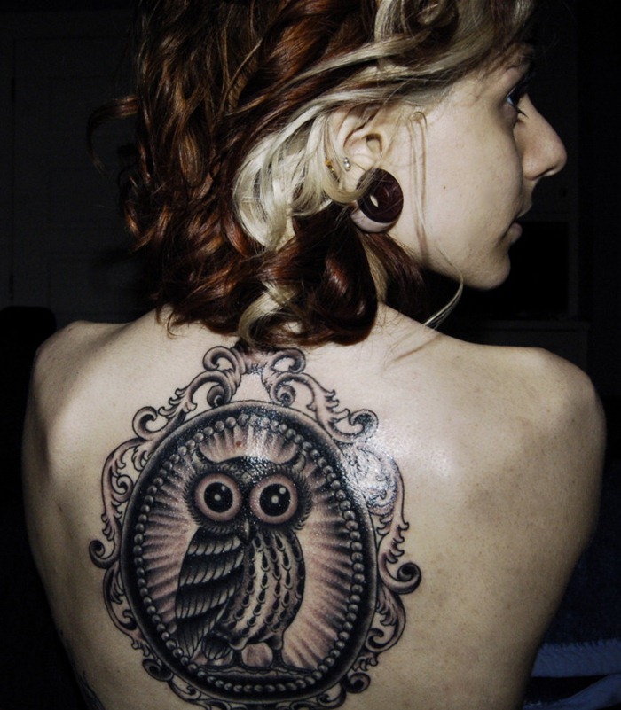 Black Ink Owl In Frame Tattoo On Girl Upper Back