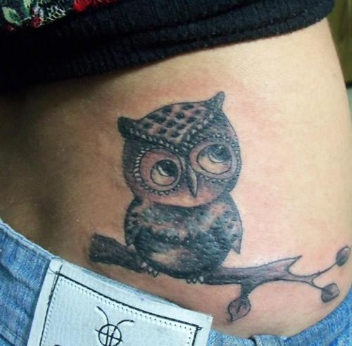 Black Ink Owl On Branch Tattoo On Girl Lower Back