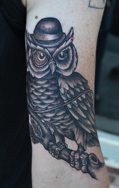Black Ink Owl On Branch Tattoo On Man Left Bicep By Jeff Johnson