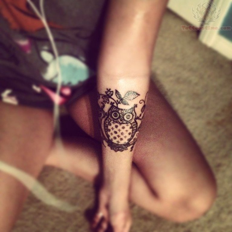 Black Ink Owl Tattoo On Girl Left Forearm