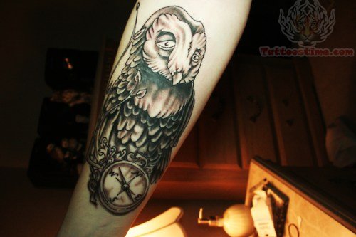 Black Ink Owl With Compass Tattoo On Forearm