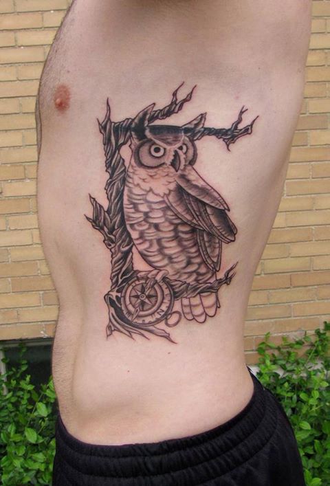 Black Ink Owl With Compass Tattoo On Man Left Side Rib