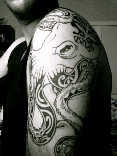 Black Ink Tribal Octopus Tattoo On Man Left Shoulder