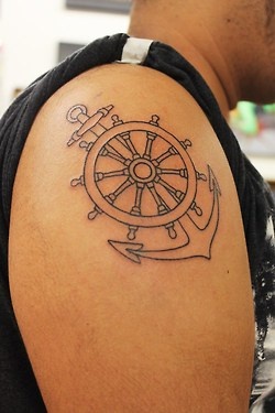 Black Outline Anchor With Wheel Tattoo On Man Right Shoulder