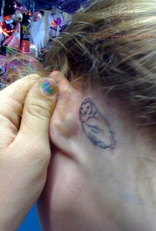 Black Outline Owl Tattoo On Girl Left Behind The Ear