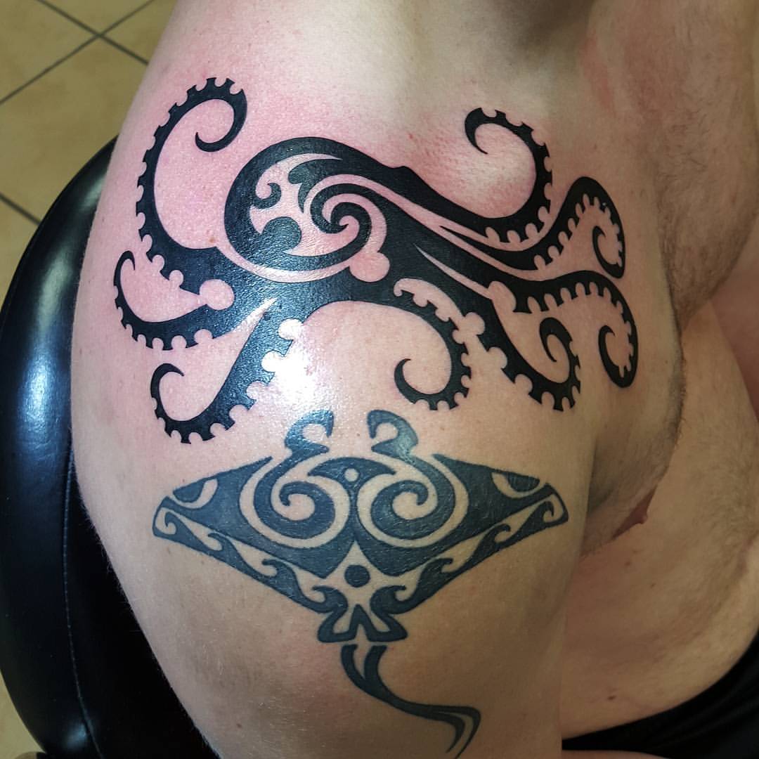 Black Tribal Manta Ray Fish With Octopus Tattoo On Man Right Shoulder