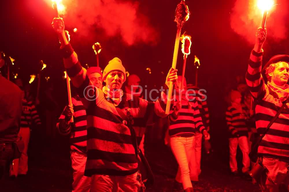 Bonfire Society Members Carry Burning Torches During Guy Fawkes Parade