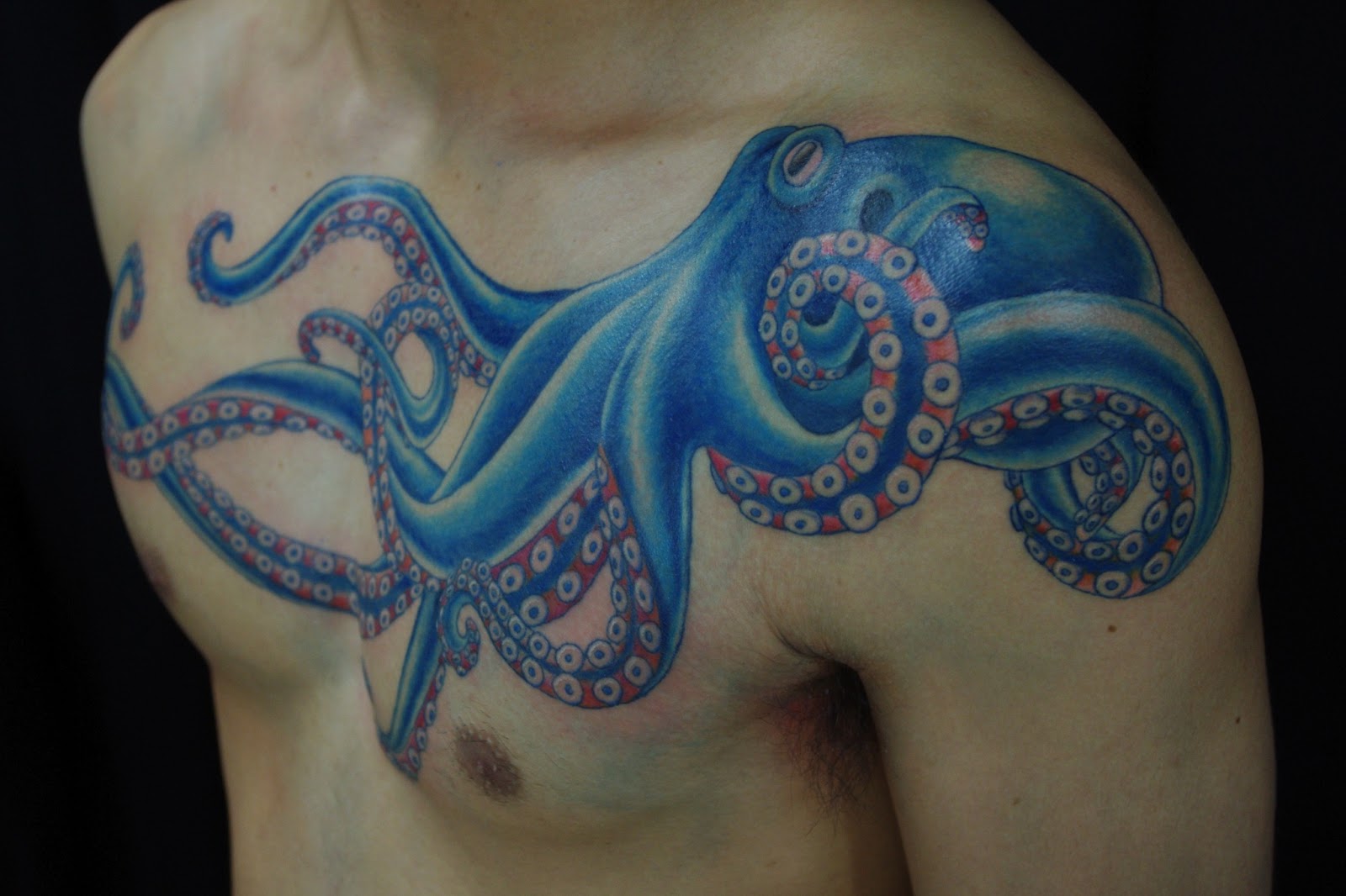 Classic Colorful Octopus Tattoo On Man Left Shoulder And Chest