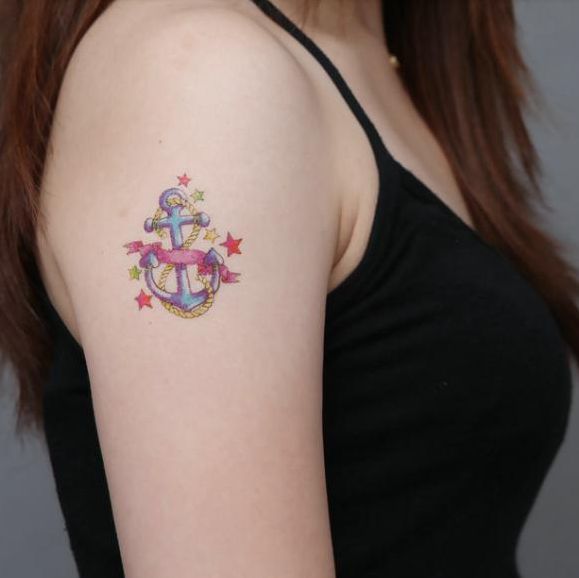 Colorful Anchor With Ribbon And Stars Tattoo On Women Right Shoulder