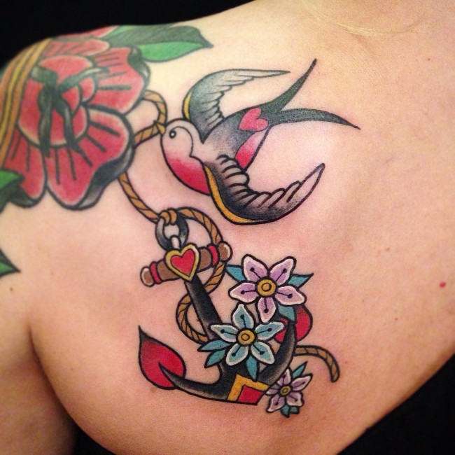 Colorful Traditional Anchor With Flowers And Flying Bird Tattoo On Left Back Shoulder