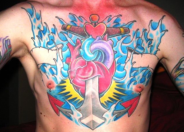 Colorful Traditional Anchor With Real Heart Tattoo On Man Chest
