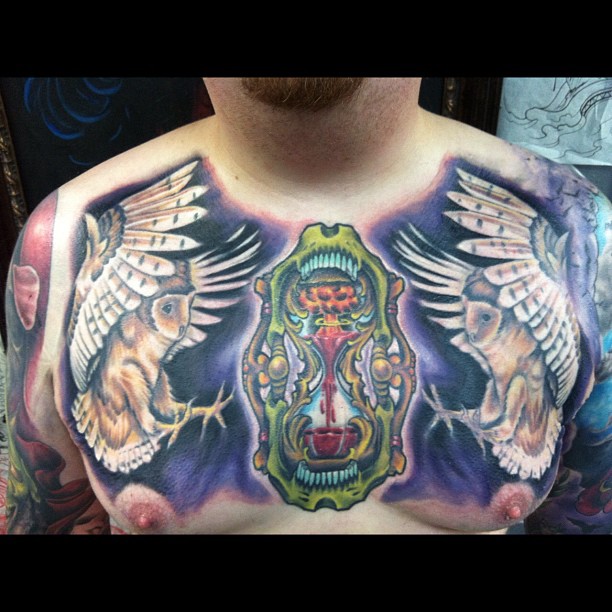 Colorful Two Owl With Hourglass Tattoo On Man Chest