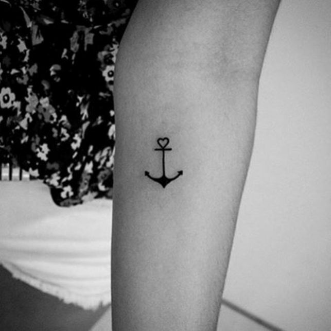Cute Black Heart Anchor Tattoo On Women Left Forearm