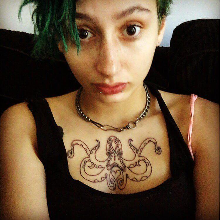 Cute Black Outline Octopus Tattoo On Girl Chest