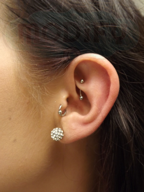 Girl Left Ear Lobe With Tragus And Rook Piercing