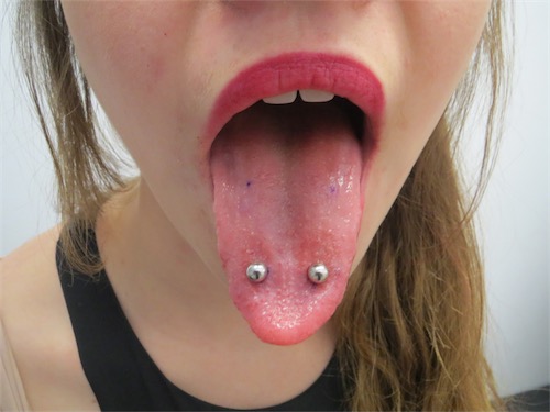 Girl Showing Her Tongue Venom Piercing