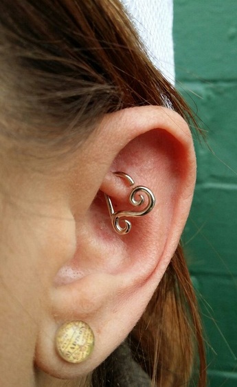 Girl With Ear Lobe And Rook Piercing