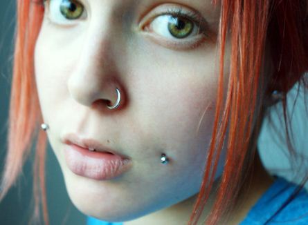 Girl With Left Nostril And Cheek Piercing