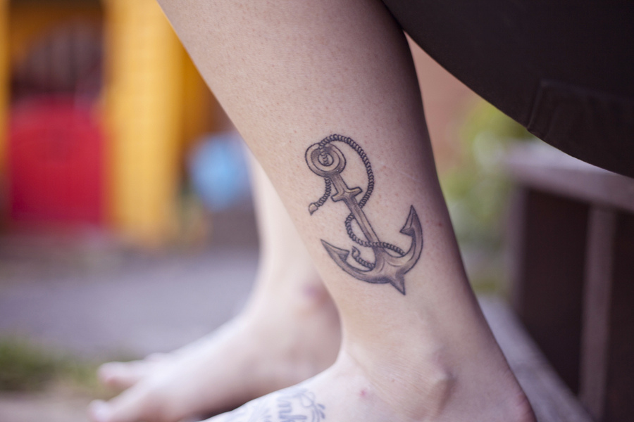 Grey Ink Anchor Tattoo On Girl Left Leg