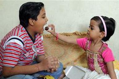 Happy Bhai Dooj Sister Offering Sweets To Brother