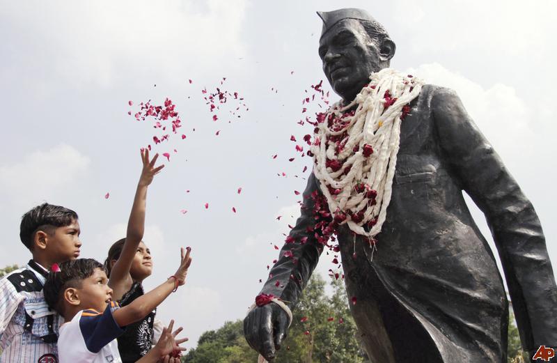 Kids Showering Flowers On The Statue Of Jawaharlal Nehru During Children's Day Celebration