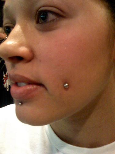 Labret And Cheek Piercing With Silver Studs