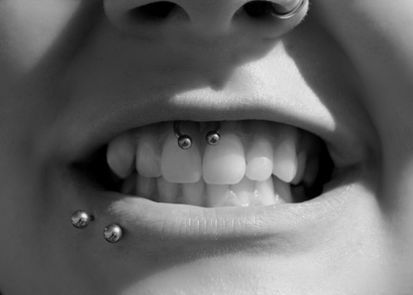 Left Nostril, Lower Lip And Smiley Piercing