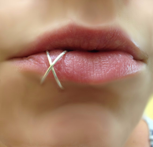 Lower Lip Piercing With Silver Hoop Rings